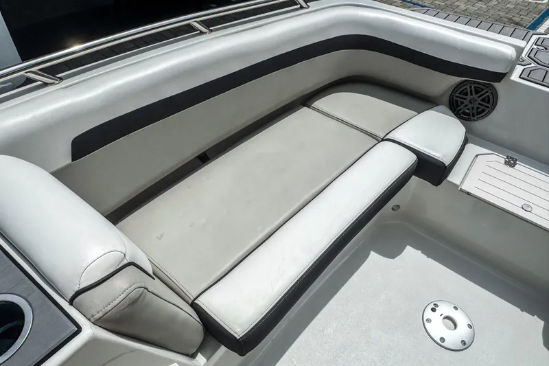 Slide: The Image of 2024 Starcraft SVX 211 OB boat interior with cushioned seating and speaker. - 14