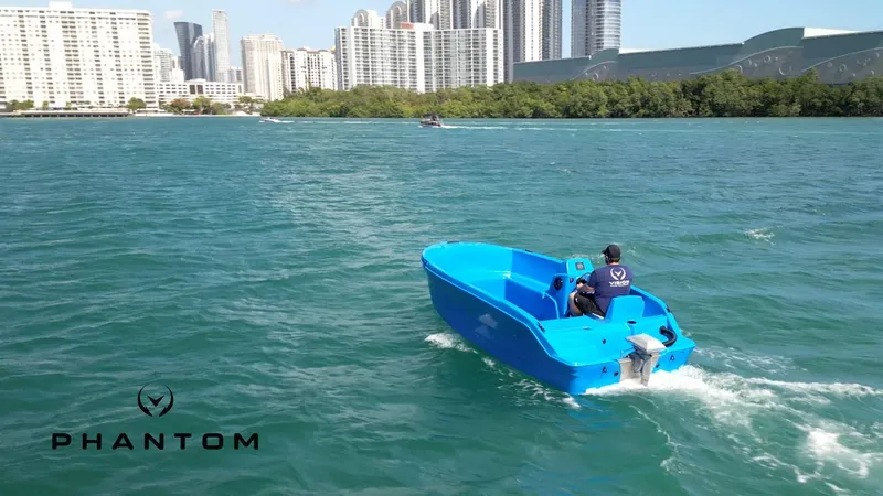 Slide: The Image of 2024 Vision Marine Technologies Phantom boat cruising in urban waters. - 8