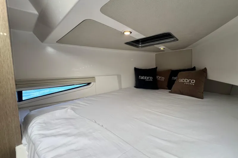Slide: The Image of Cozy cabin interior of 2026 Fabbro F33 yacht with branded pillows. - 19