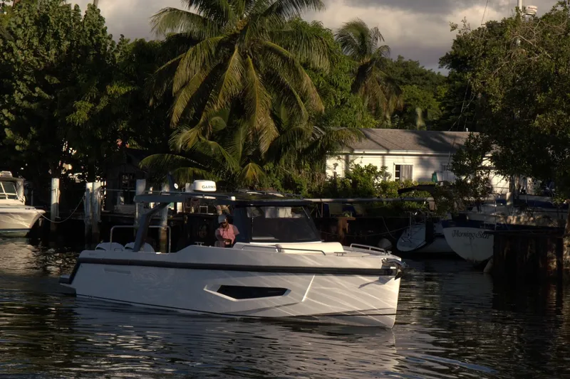 Slide: The Image of Fabbro F33 yacht in urban waterfront setting, 2026 model. - 2