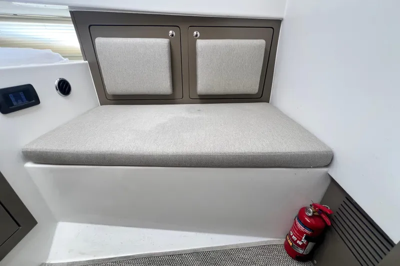 Slide: The Image of Interior of 2026 Fabbro F33 boat with cushioned seating and fire extinguisher. - 23