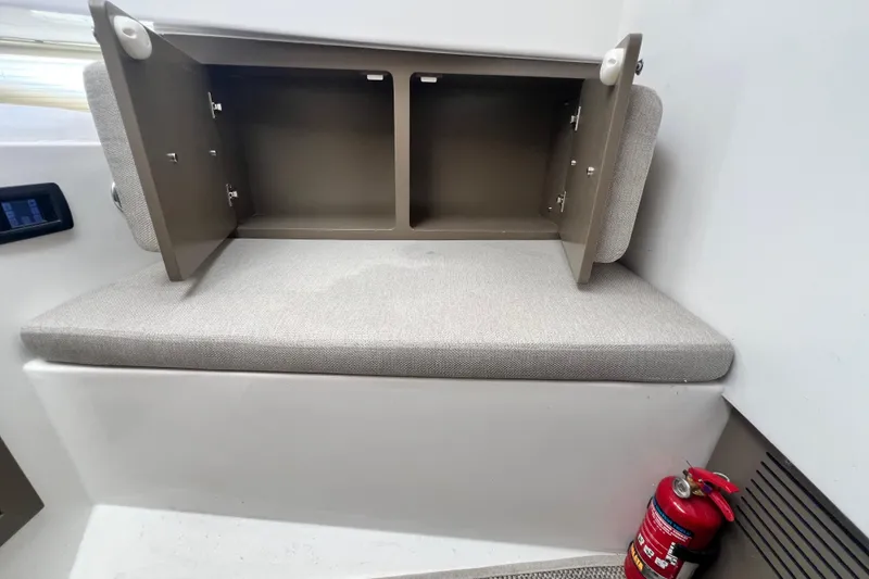 Slide: The Image of Interior of 2026 Fabbro F33 boat with open storage and fire extinguisher. - 24