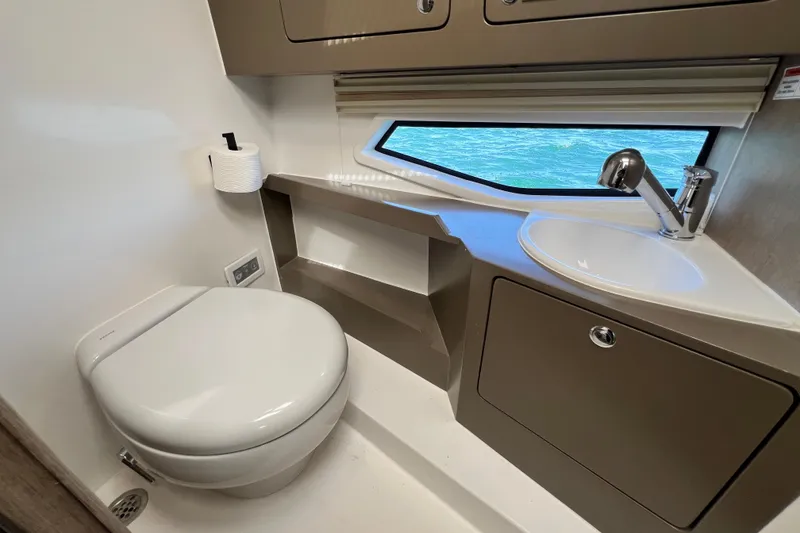 Slide: The Image of Modern Fabbro F33 2026 yacht bathroom with toilet, sink, and ocean view window. - 26