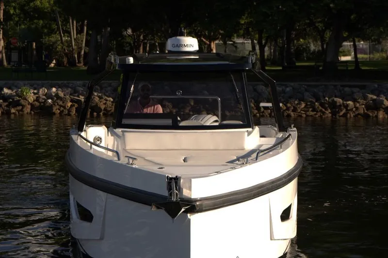 Slide: The Image of 2026 Fabbro F33 boat cruising near modern waterfront buildings. - 8