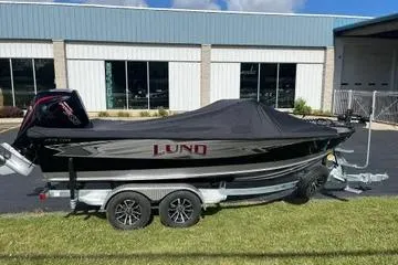 Slide: The Image of Interior of 2026 Lund 1975 Tyee boat with multiple storage compartments. - 16