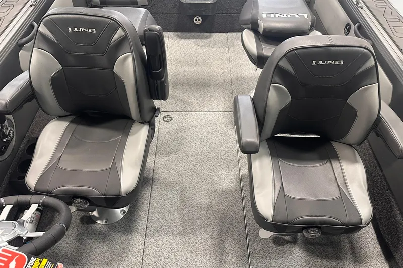 Slide: The Image of Interior of 2026 Lund 1975 Tyee boat with two black and gray seats. - 17