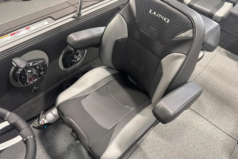 Slide: The Image of 2026 Lund 1975 Tyee boat interior with black and gray captain's chair. - 18