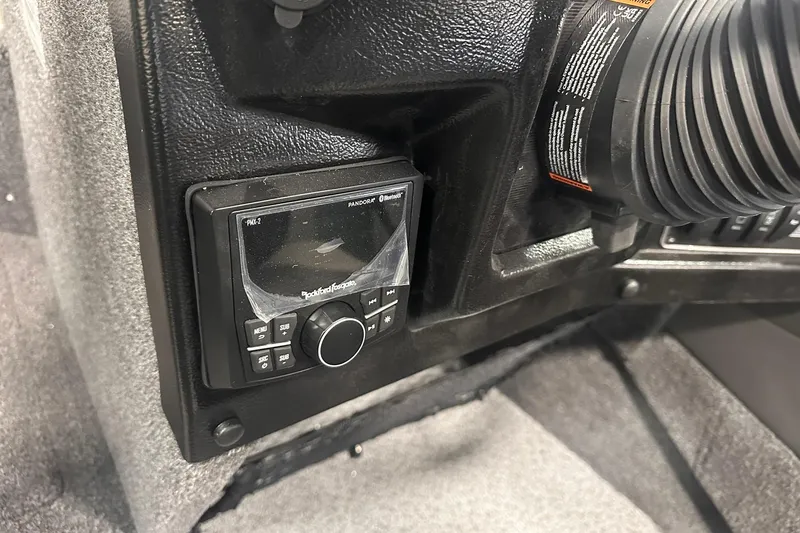 Slide: The Image of 2026 Lund 1975 Tyee boat dashboard with Rockford Fosgate audio system. - 22