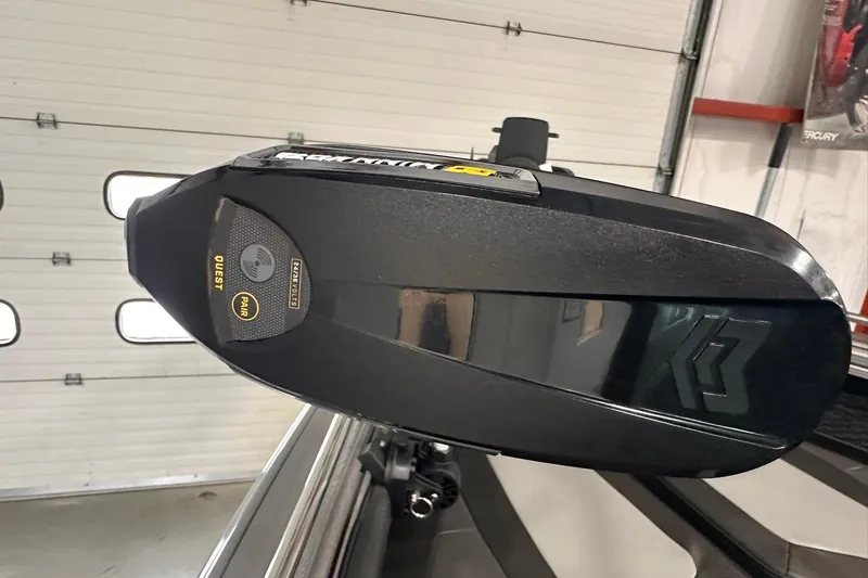 Slide: The Image of Close-up of a 2026 Lund 1975 Tyee boat motor in a garage setting. - 27