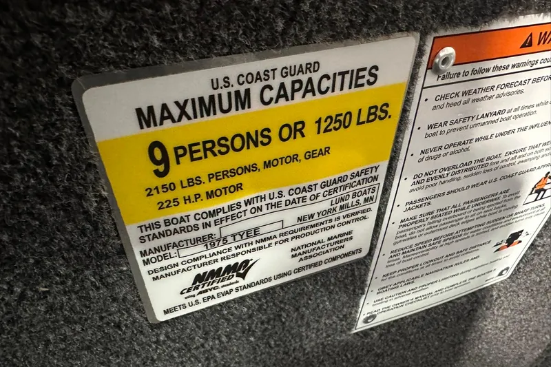 Slide: The Image of U.S. Coast Guard capacity label on 2026 Lund 1975 Tyee boat, 9 persons or 1250 lbs. - 29
