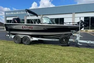 Slide: The Image of 2026 Lund 1975 Tyee boat on trailer in showroom, sleek design, modern features. - 3
