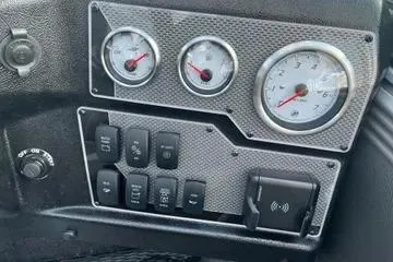 Slide: The Image of Interior of 2026 Lund 1975 Tyee boat with four black seats and steering console. - 7