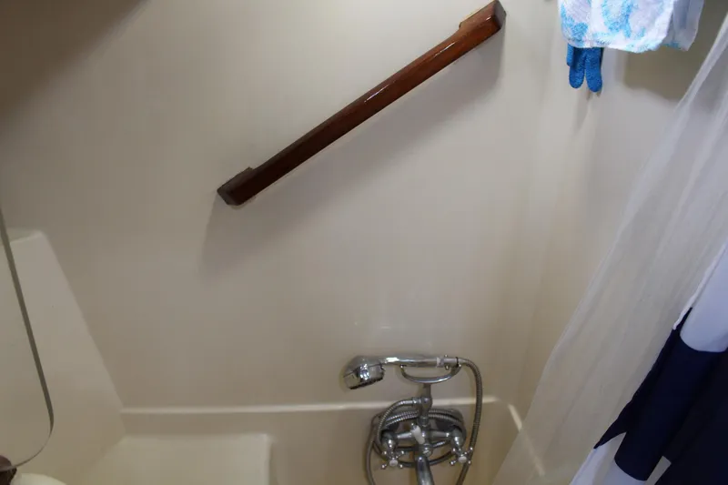 Slide: The Image of Bathroom with showerhead and wooden handrail in 1990 Slocum 43 yacht. - 23