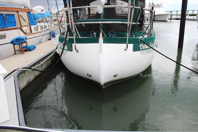 Slide: The Image of Sailboat docked at marina, Slocum 43 model, 1990, with green accents. - 4