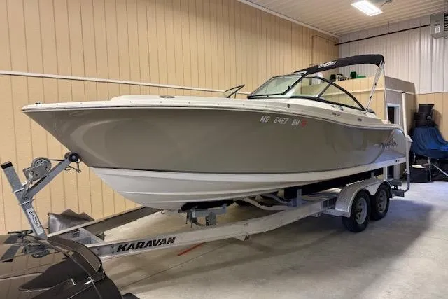 The Image of 2020 NauticStar 2302 Legacy Dual Console boat on Karavan trailer in indoor storage. - 0
