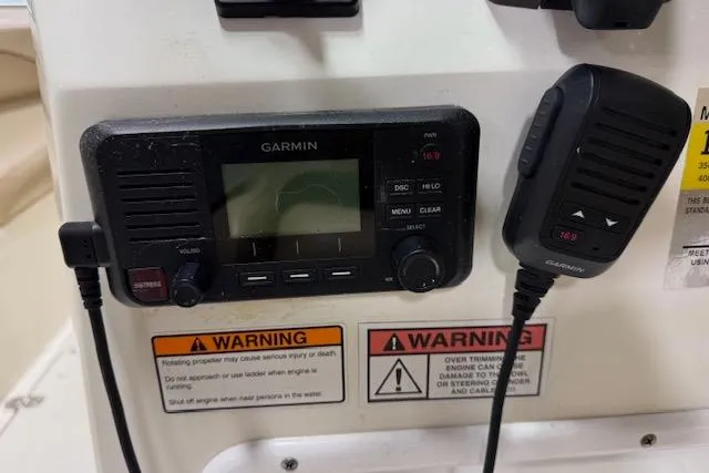 Slide: The Image of Garmin marine radio and microphone on 2020 NauticStar 2302 Legacy Dual Console boat. - 14