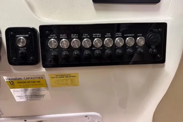Slide: The Image of Control panel of 2020 NauticStar 2302 Legacy Dual Console boat with various switches. - 16
