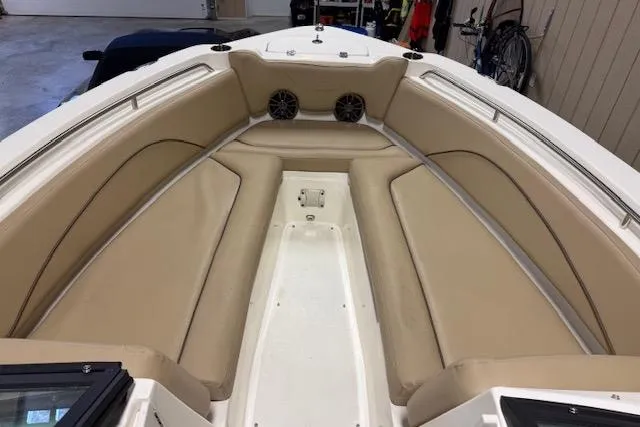 Slide: The Image of 2020 NauticStar 2302 Legacy Dual Console boat interior with beige seating. - 18