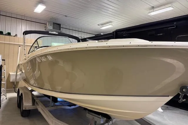 Slide: The Image of 2020 NauticStar 2302 Legacy Dual Console boat in indoor storage on trailer. - 2
