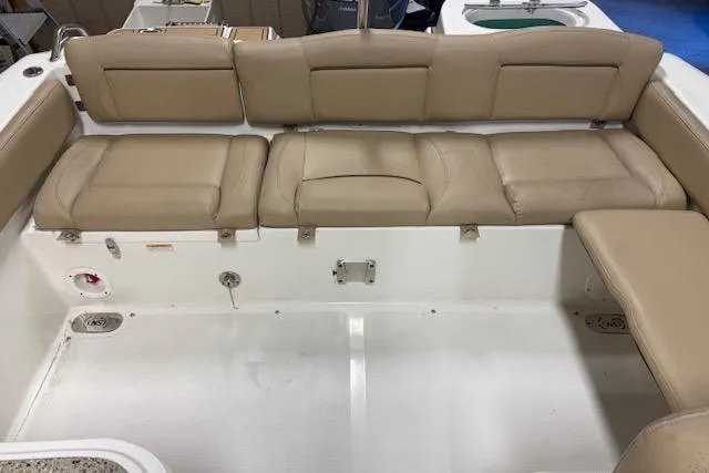 Slide: The Image of 2020 NauticStar 2302 Legacy Dual Console boat with beige cushioned seating. - 23
