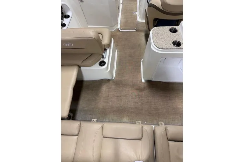 Slide: The Image of Interior of 2020 NauticStar 2302 Legacy Dual Console with beige seating and carpeted floor. - 25