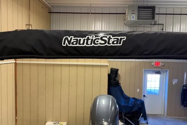 Slide: The Image of 2020 NauticStar 2302 Legacy Dual Console boat in storage with cover. - 35