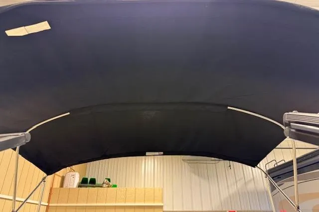 Slide: The Image of 2020 NauticStar 2302 Legacy Dual Console boat canopy in indoor storage. - 36