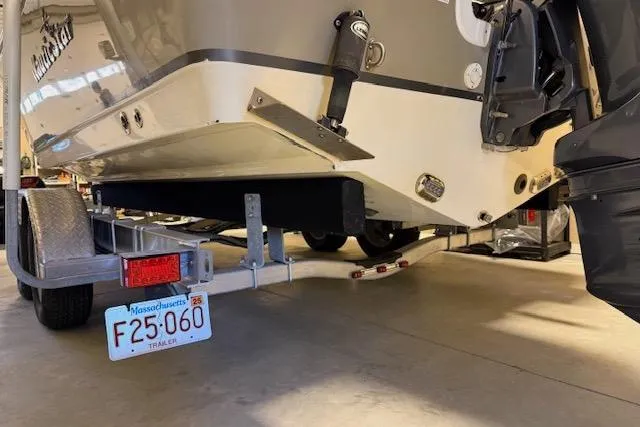 Slide: The Image of 2020 NauticStar 2302 Legacy Dual Console boat on trailer, Massachusetts license plate visible. - 41