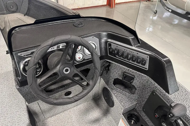 Slide: The Image of 2026 Lund 1775 Impact XS SS boat dashboard with steering wheel and control panel. - 16