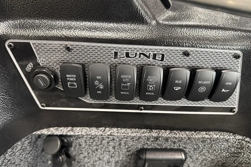 Slide: The Image of Control panel of 2026 Lund 1775 Impact XS SS boat with various switches. - 17