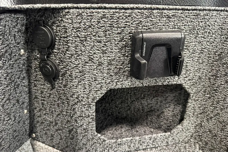 Slide: The Image of 2026 Lund 1775 Impact XS SS interior with USB and 12V ports, textured finish. - 18