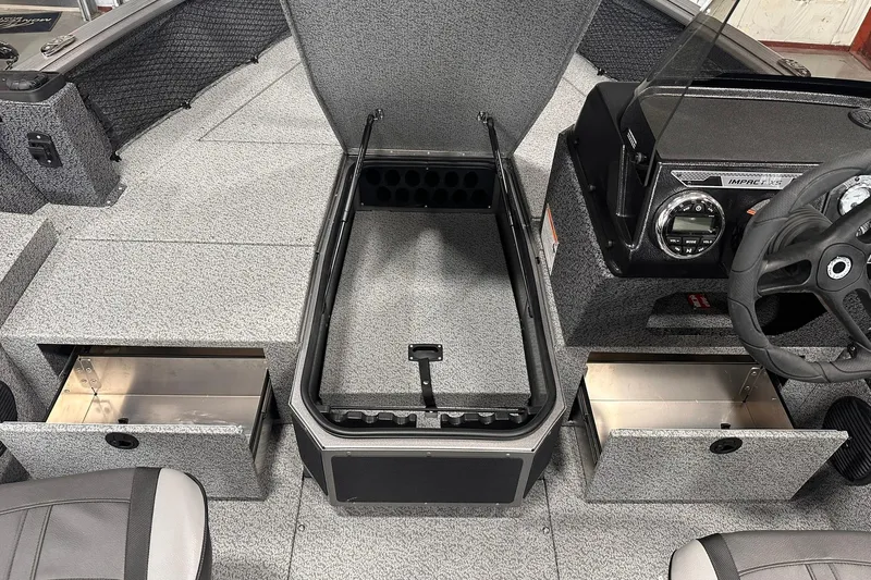 Slide: The Image of 2026 Lund 1775 Impact XS SS boat interior with storage compartments and steering console. - 22