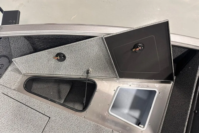 Slide: The Image of 2026 Lund 1775 Impact XS SS boat storage compartments with open hatches. - 24