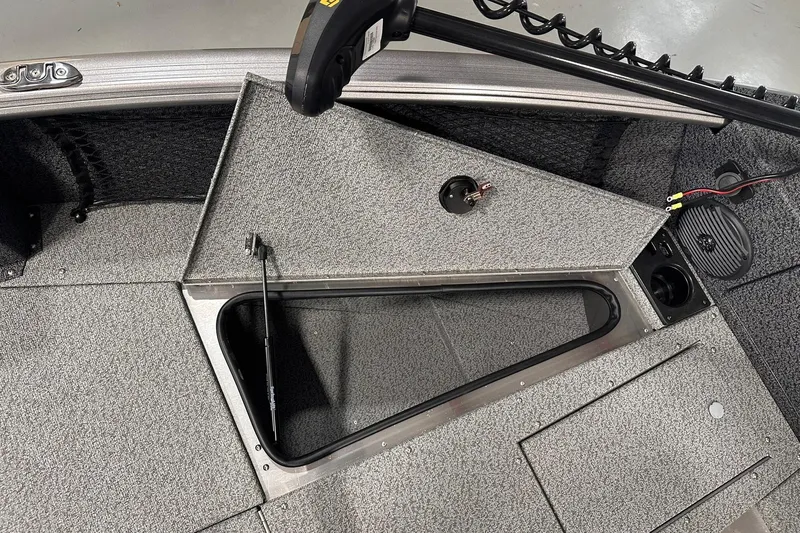Slide: The Image of 2026 Lund 1775 Impact XS SS boat interior with open storage compartment. - 26
