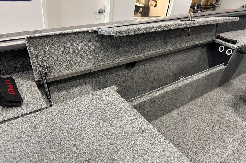 Slide: The Image of 2026 Lund 1775 Impact XS SS boat interior storage compartments. - 29