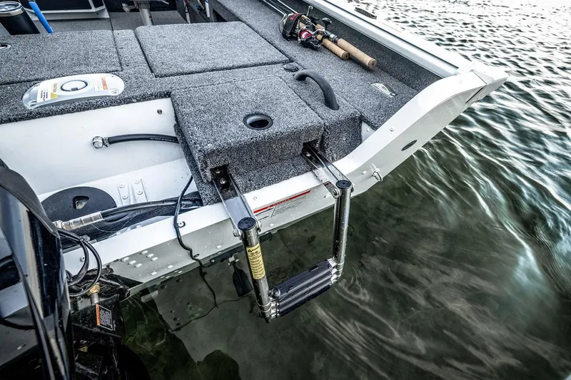 Slide: The Image of 2026 Lund 1775 Impact XS SS boat in showroom with powerful outboard motor. - 3