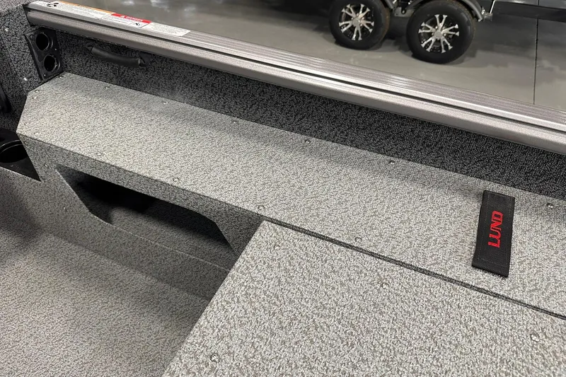 Slide: The Image of Interior view of 2026 Lund 1775 Impact XS SS boat, featuring textured flooring and storage compartments. - 30