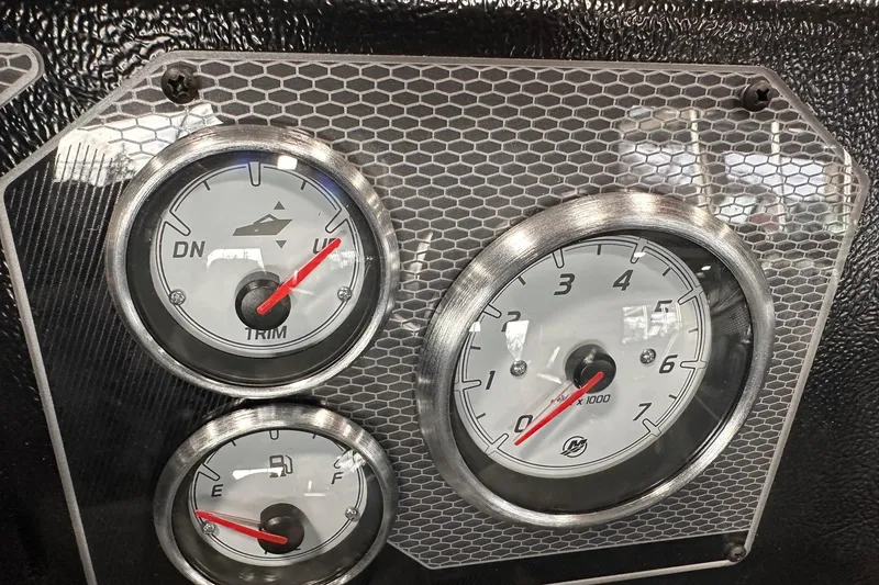 Slide: The Image of Dashboard gauges of 2026 Lund 1775 Impact XS SS boat, featuring trim and fuel indicators. - 31