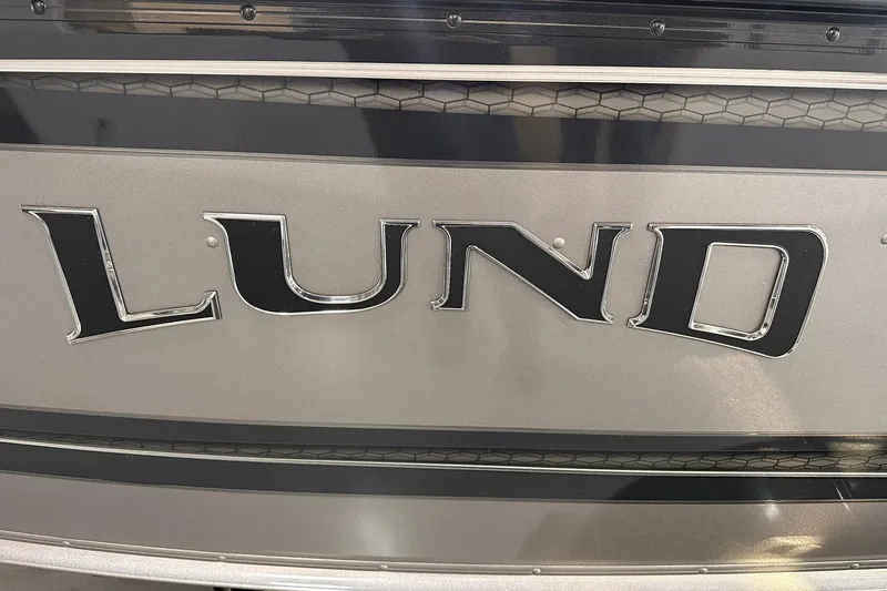 Slide: The Image of Close-up of 2026 Lund 1775 Impact XS SS boat logo on metallic surface. - 32