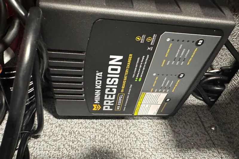 Slide: The Image of Minn Kota Precision on-board battery charger in Lund 1775 Impact XS SS, 2026 model. - 34