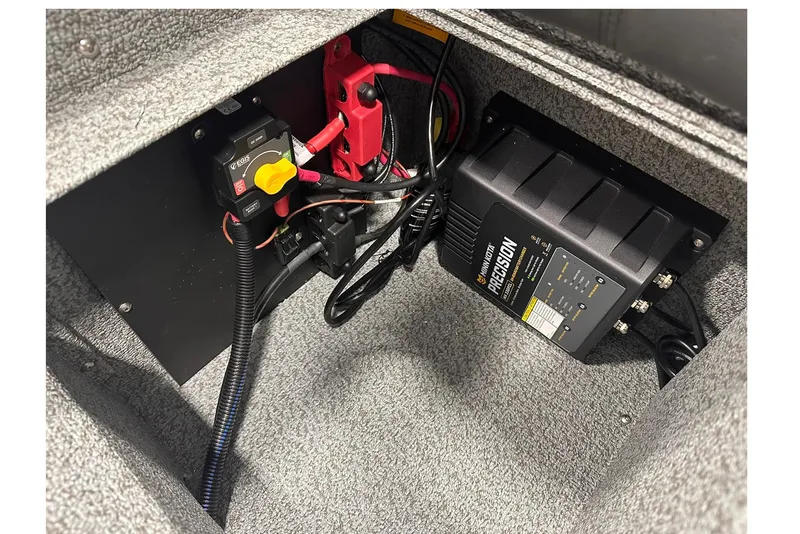 Slide: The Image of 2026 Lund 1775 Impact XS SS boat battery compartment with precision charger and wiring. - 36