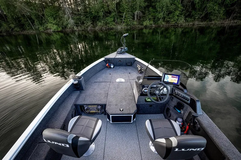 Slide: The Image of 2026 Lund 1775 Impact XS SS boat displayed in showroom on trailer. - 4