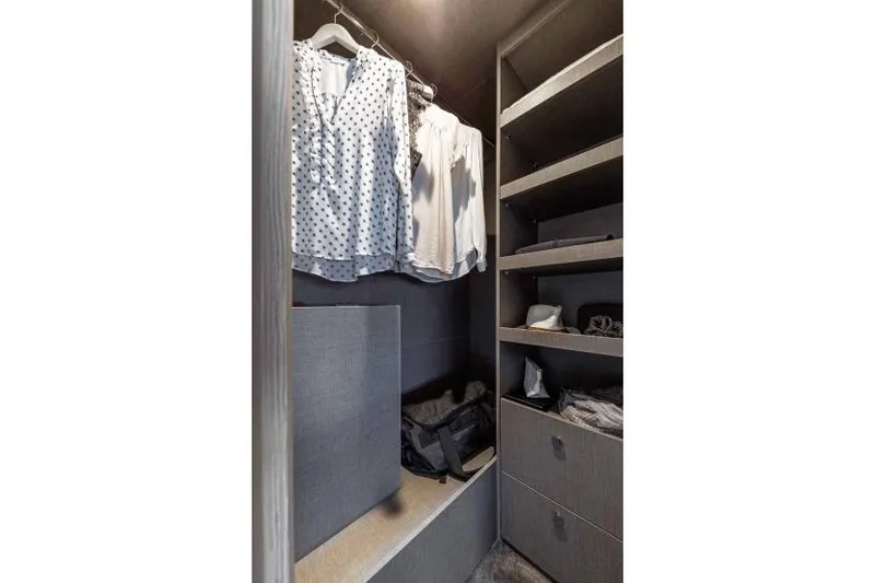 Slide: The Image of Luxurious closet interior on Azimut Fly 53 yacht, featuring organized shelves and hanging clothes. - 19