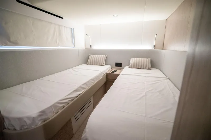Slide: The Image of Twin cabin interior of 2026 Azimut Fly 53 yacht, featuring modern design and cozy bedding. - 21