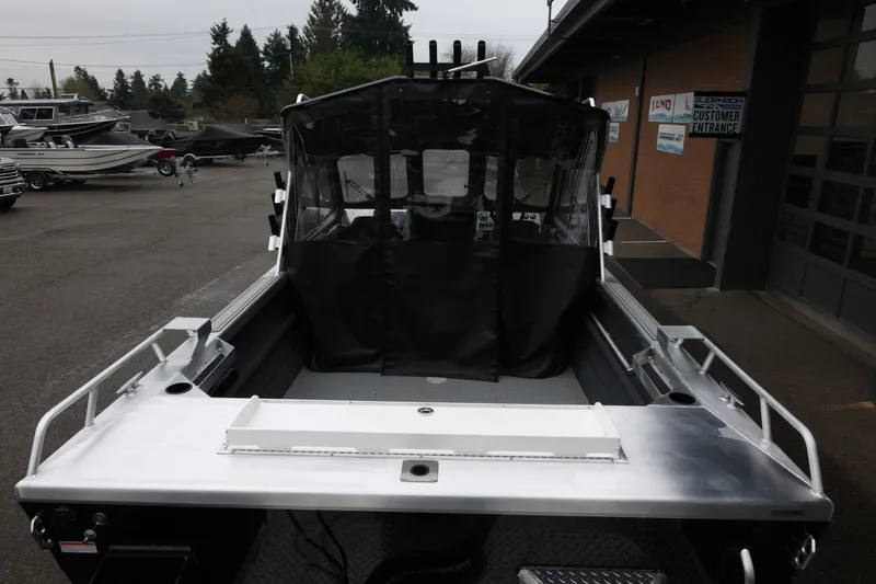 Slide: The Image of 2026 Thunder Jet 210 Luxor Limited boat, rear view at dealership. - 13