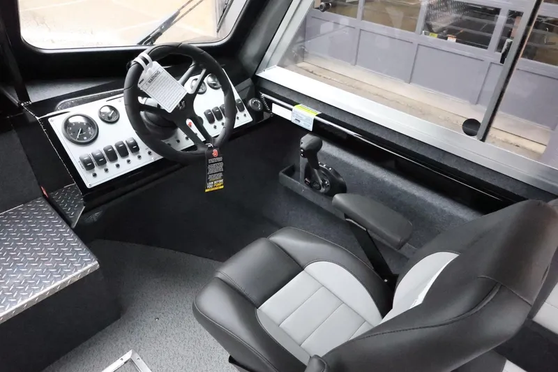Slide: The Image of Interior of 2026 Thunder Jet 210 Luxor Limited boat, featuring steering wheel and control panel. - 20