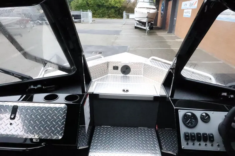 Slide: The Image of Interior view of 2026 Thunder Jet 210 Luxor Limited boat cockpit with diamond plate flooring. - 21