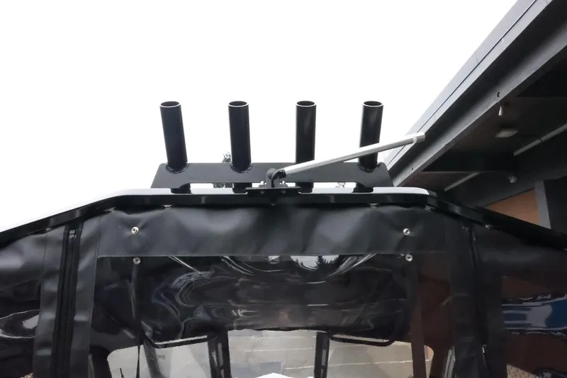 Slide: The Image of 2026 Thunder Jet 210 Luxor Limited boat with rod holders and canopy detail. - 46