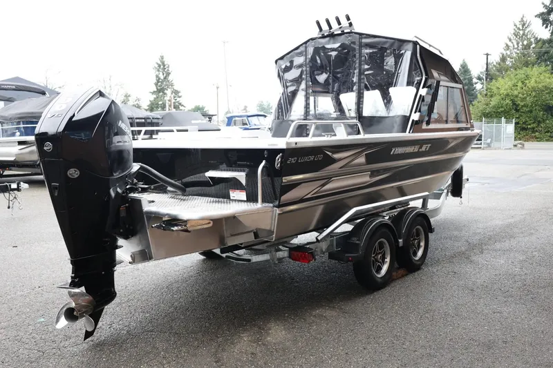 Slide: The Image of 2026 Thunder Jet 210 Luxor Limited boat on trailer, featuring sleek design and powerful outboard motor. - 6