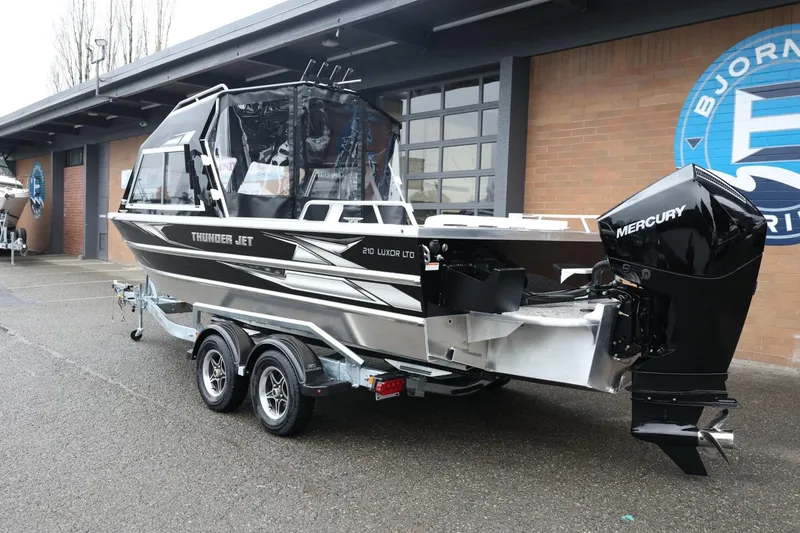 Slide: The Image of 2026 Thunder Jet 210 Luxor Limited boat with Mercury engine on trailer. - 8